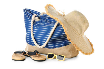 Striped bag and beach accessories isolated on white background, closeup