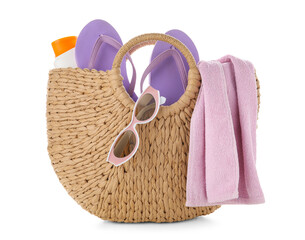 Wicker bag with bottle of sunscreen cream and beach accessories isolated on white background,...