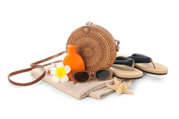 Wicker bag, bottle of sunscreen cream, flower and beach accessories isolated on white background,...