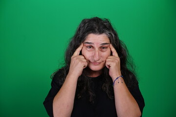 Unedited Portrait of Woman’s Face Expressing Various Emotions – Green Studio Background