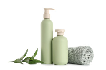 Composition with bottles of shower gel, green twig and towel isolated on white background, closeup
