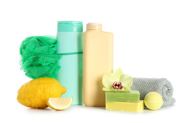 Composition with bottles of shower gel, soap bars, lemon and bath sponge isolated on white...