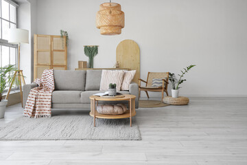 Interior of living room with soft couch, table and lamps