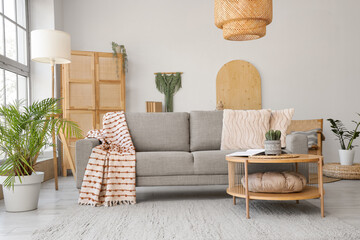 Interior of living room with soft couch, table and lamps