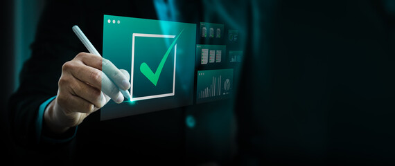 Businessman using digital pen to mark virtual check mark icon on futuristic interface, symbolizing...