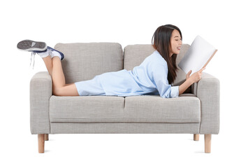 Young Asian woman reading magazine on grey sofa against white background