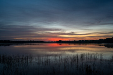 Obraz premium Colorful sunrise cloudscape reflected in calm water of Nine Mile Pond in Everglades National Park, Florida.