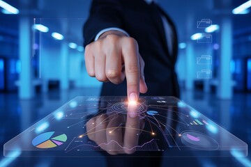 Person's finger touching a glowing digital interface with charts graphs and data visualization in a blue-toned environment