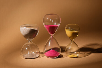 Crystal hourglasses on beige background