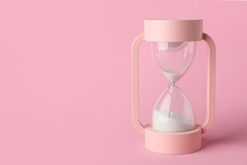 Crystal hourglass on pink background