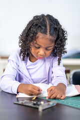 A smart smiling afro or african american new generation girl curly hair style staring learnning...