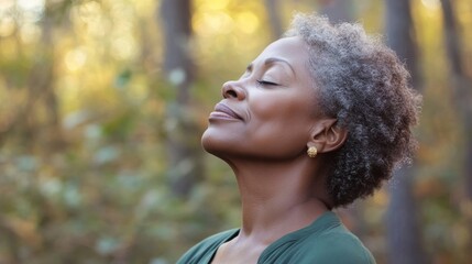 Serene elderly African-American woman in forest, eyes closed meditation, relaxed Mature Black American breathing
