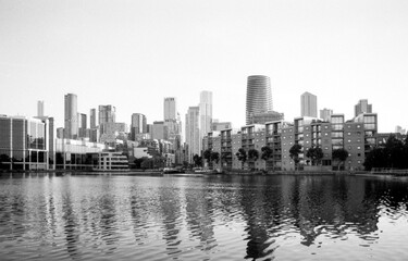 Modern skyline reflecting on calm water in canary wharf, london, uk