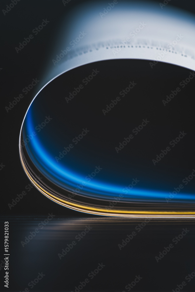 Poster curved paper with glowing edge: abstract close-up of a curved piece of paper illuminated with a vibr