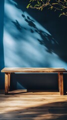 Wooden Table with Leaf Shadows on Blue Wall, Natural Light and Texture
