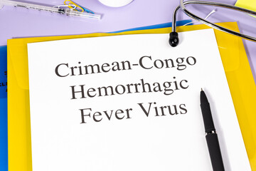 A Paper with “Crimean-Congo Hemorrhagic Fever Virus” Title in Clipboard Set on the Desk with...