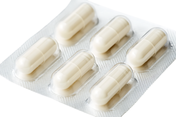 Close up of six white capsules in a blister pack.