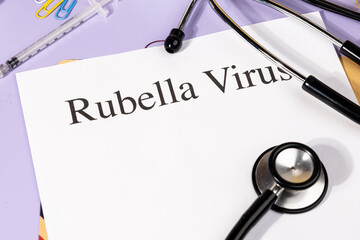 A Paper with “Rubella Virus” Title in Clipboard Set on the Desk with Stethoscope – German...