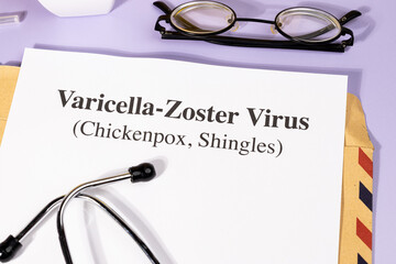 A Paper with “Varicella-Zoster Virus” Title in Clipboard Set on the Desk with Stethoscope –...