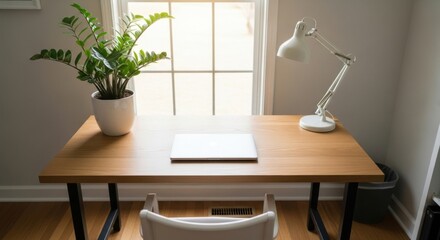 A Simple Wooden Desk With A Laptop A Desk Lamp And A Potted Plant