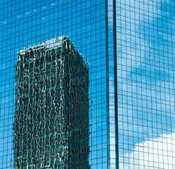 Skyscraper abstract with reflection in Sydney Australia, showing lines, and patterns of a glass building with nearby skyscraper in a distorted reflection_20101218_05623