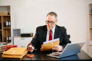 Senior judge or lawyer working in office with legal book and gavel. Perfect for law, courtroom, justice, and legal advice