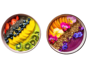 Top-down view of two vibrant smoothie bowls arranged in rainbow layers with colorful toppings