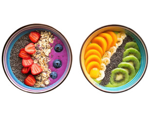 Top-down view of two vibrant smoothie bowls arranged in rainbow layers with colorful toppings