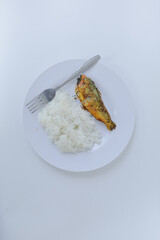 A simple and traditional Indonesian meal consisting of steamed white rice and a piece of fried fish...