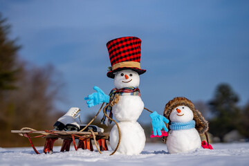 Funny snowman in winter background. Snowman in winter holiday. Decorated snowman. Greeting card for...