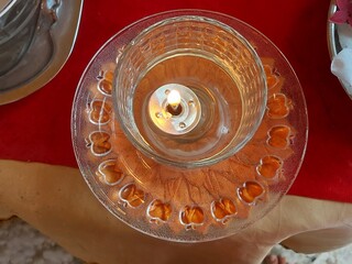 Glass candle holder. Decorative table light. Elegant candle decoration. Festive table setting....