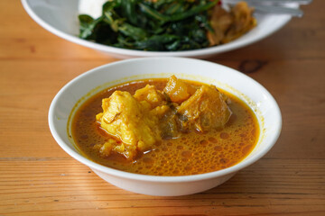Nasi Padang Kikil, Indonesia, captured on July 13, 2025. Steamed rice served with spicy Padang-style beef tendon curry, vegetables, sambal, and rich coconut gravy for bold Minang flavor