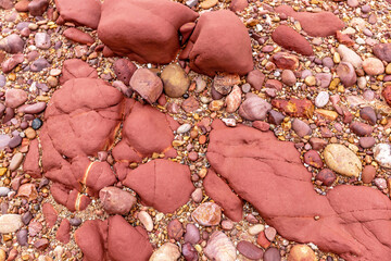 Small colorful rocks on the sandy beach