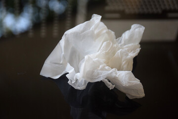 White crumpled tissue paper on a dark background