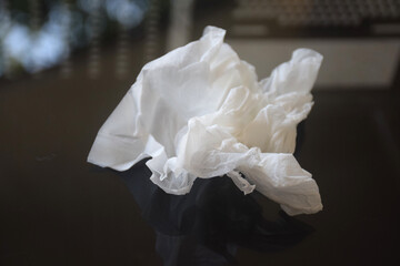 White crumpled tissue paper on a dark background