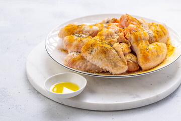 Raw chicken wings, with dry rub and olive oil prepared for bbq