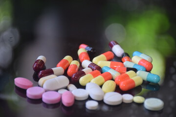 Illustration of various capsules used for treatment against a dark background
