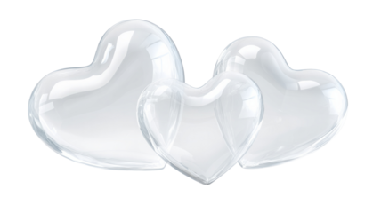 Three hearts made of clear glass are arranged in a row