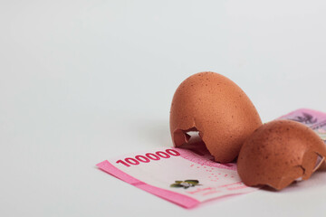 Cracked Egg with Indonesian Rupiah – Concept of Food Inflation and Rising Living Costs