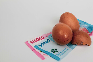 Cracked Egg with Indonesian Rupiah – Concept of Food Inflation and Rising Living Costs