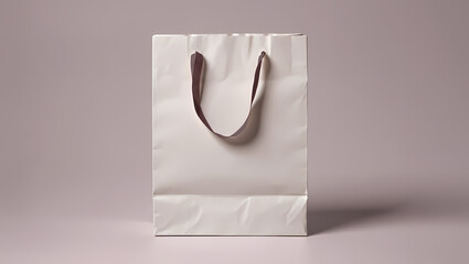 Clean Empty White Paper Shopping Bag with Gold-Colored Handles on a Neutral Grey Background, Ideal for Retail Branding, Gifts, and Product Packaging Mockups.