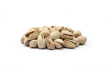 A healthy pile of roasted and salted in-shell pistachio nuts isolated on a white background.