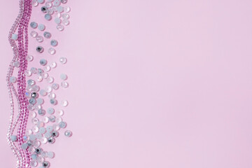 Rhinestone Chains and Beads on Pink Background with Copy Space