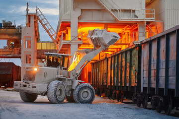Wheel loader loads limestone into freight gondola cars