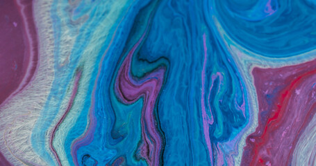 Chemical spill. Floating ink texture. Defocused blue purple color neon rainbow sparkling water...