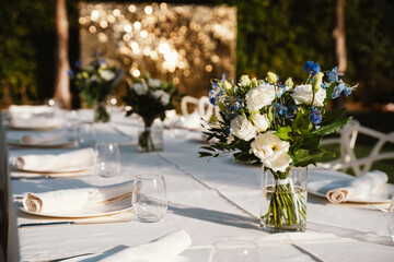Elegant Outdoor Table Setting with Floral Arrangements