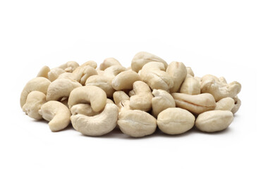 A healthy side view of a pile of raw shelled cashew nuts isolated on white.