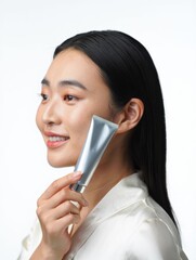 Woman Holding Skincare Tube with Elegant Expression