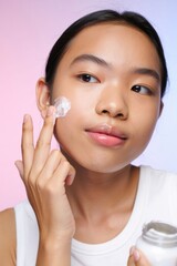 Young Woman Applying Cream with Gentle Touch