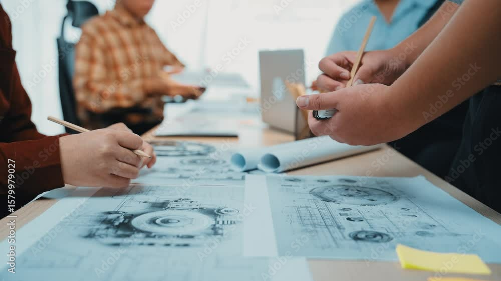 Poster a diverse team of professionals engages in a brainstorming session, analyzing architectural designs 